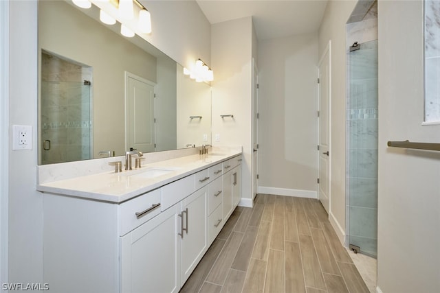 bathroom featuring vanity and an enclosed shower