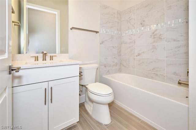 full bathroom with vanity, toilet, and tiled shower / bath