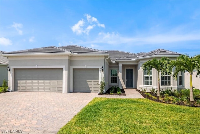 view of front of home with a front yard and a garage