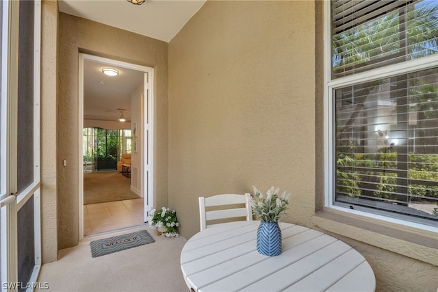 entrance to property with outdoor dining space, a patio area, and stucco siding