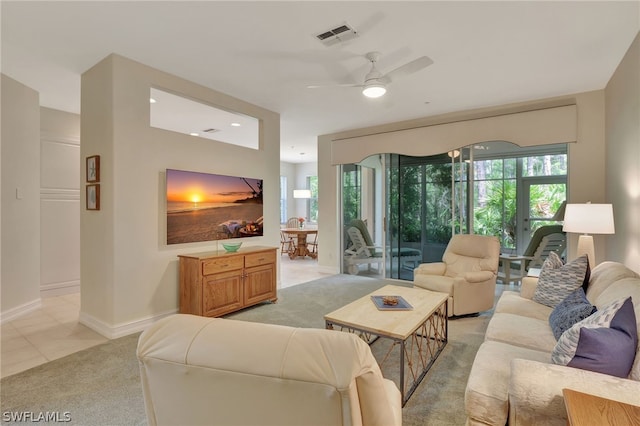 carpeted living room featuring ceiling fan