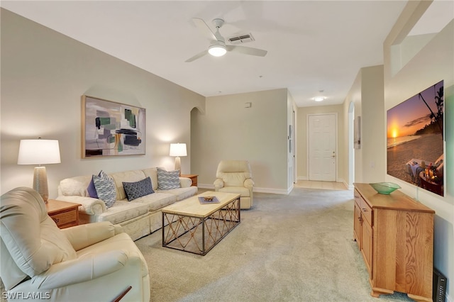 living room featuring light colored carpet and ceiling fan