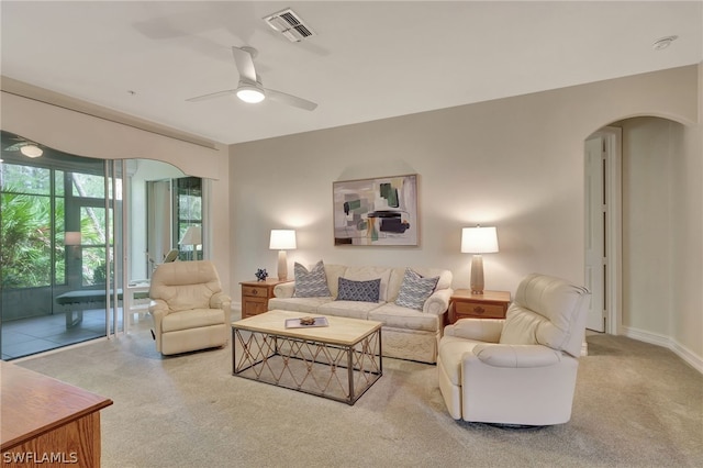 living room featuring ceiling fan and light colored carpet