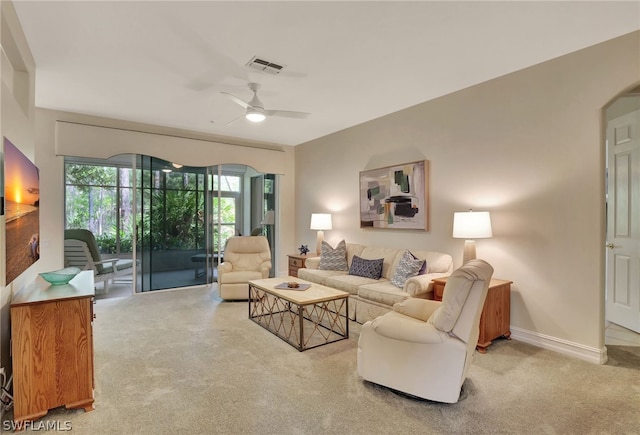 living room featuring light carpet and ceiling fan