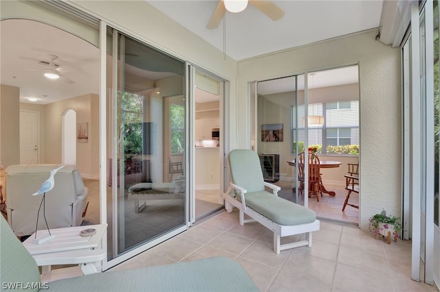 sunroom featuring ceiling fan