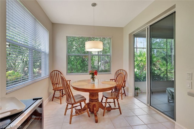 dining space with light tile patterned floors and baseboards