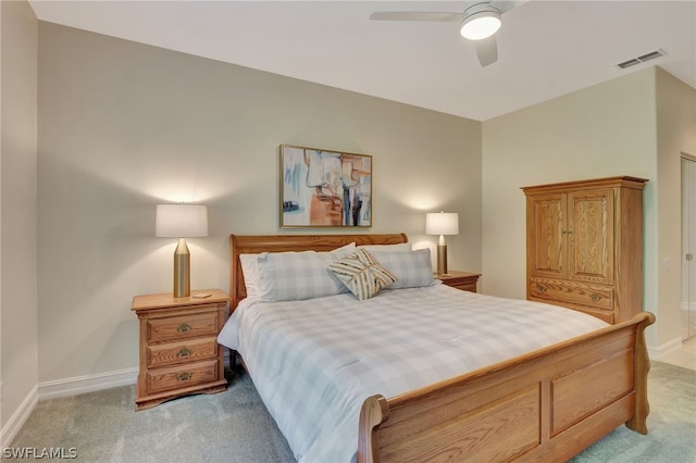 bedroom featuring a ceiling fan, light colored carpet, visible vents, and baseboards