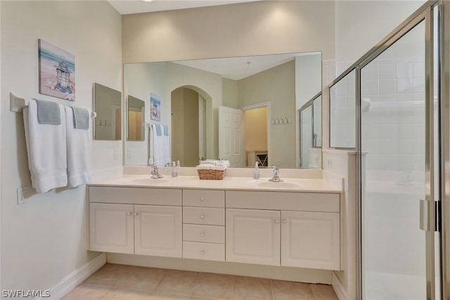 bathroom with tile patterned flooring, vanity, and a shower with shower door