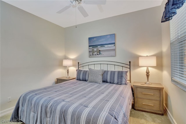 bedroom featuring light carpet and ceiling fan