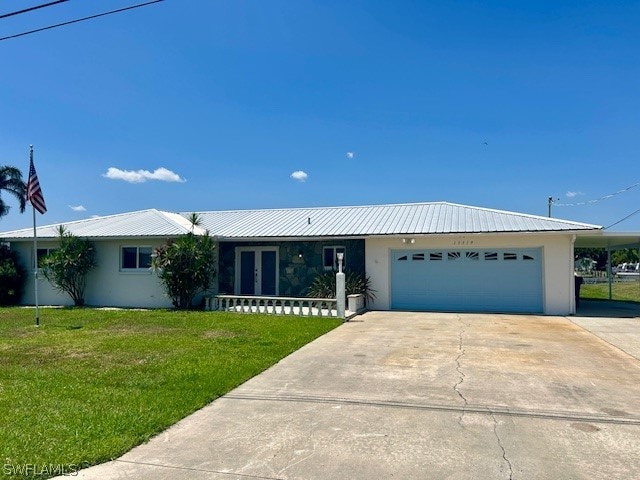 single story home featuring a front lawn and a garage