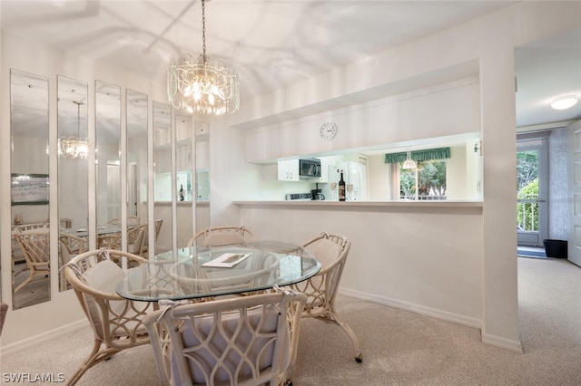 dining space featuring light carpet and a chandelier