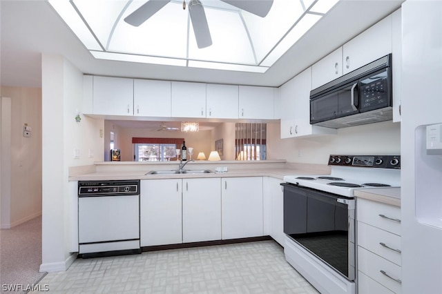 kitchen with ceiling fan, sink, light colored carpet, white appliances, and white cabinets