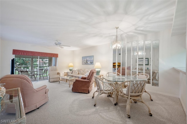 carpeted dining area with ceiling fan with notable chandelier