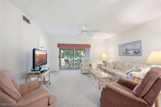 carpeted living room with ceiling fan