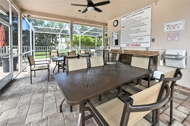 sunroom featuring ceiling fan