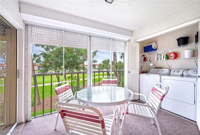 sunroom featuring washing machine and dryer