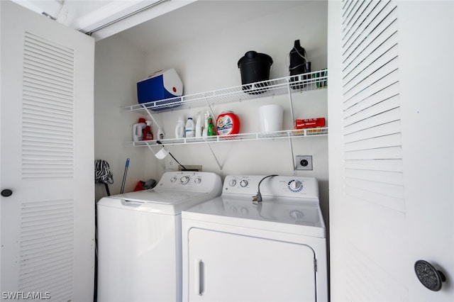 clothes washing area featuring separate washer and dryer