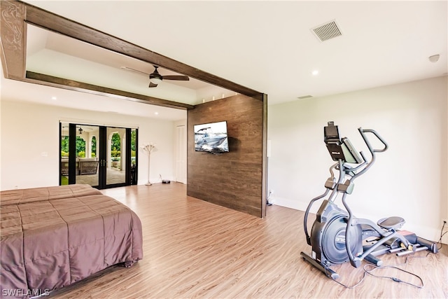 bedroom featuring french doors, access to outside, beam ceiling, wood-type flooring, and ceiling fan