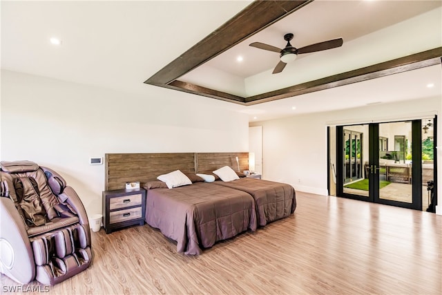 bedroom with ceiling fan, french doors, a raised ceiling, access to outside, and hardwood / wood-style flooring