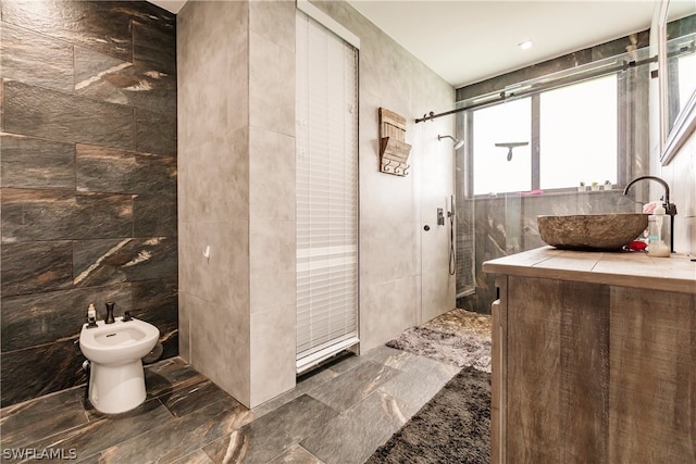 bathroom with a bidet, tile walls, tile floors, and a tile shower