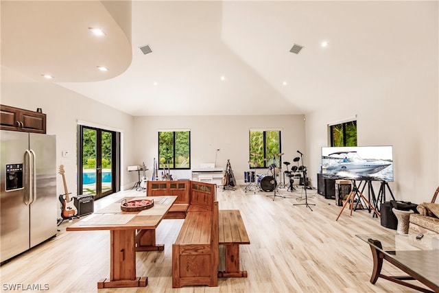 dining space with light hardwood / wood-style floors and a healthy amount of sunlight