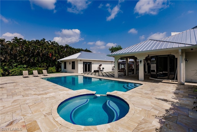 view of pool with an in ground hot tub and a patio