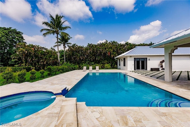 view of pool with a patio area and an in ground hot tub