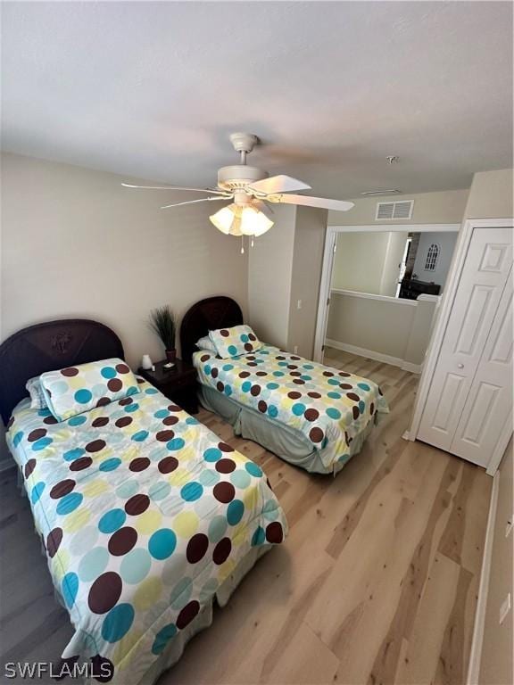 bedroom with light hardwood / wood-style floors and ceiling fan