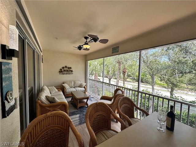 sunroom featuring ceiling fan