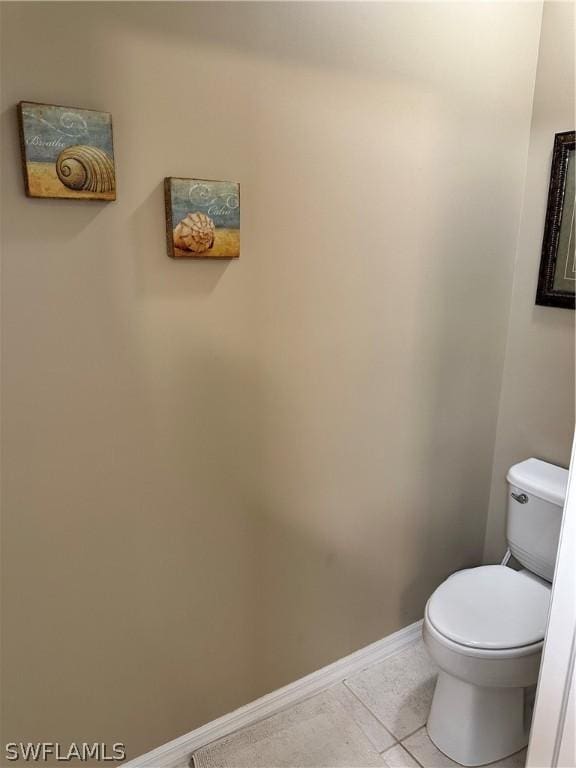 bathroom with toilet and tile patterned flooring