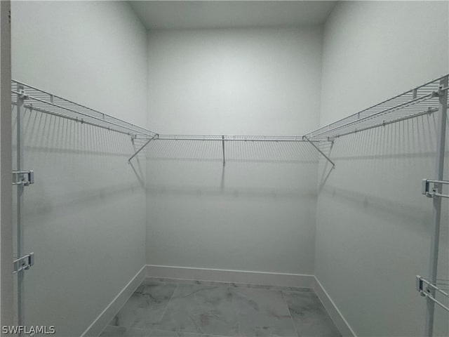 spacious closet with tile flooring