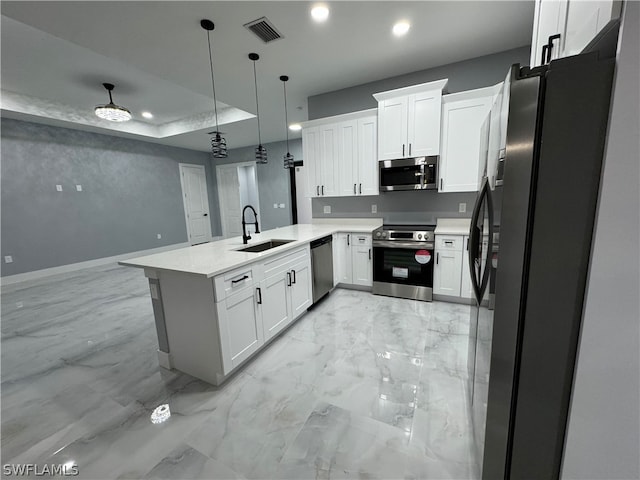 kitchen with kitchen peninsula, stainless steel appliances, sink, light tile floors, and pendant lighting