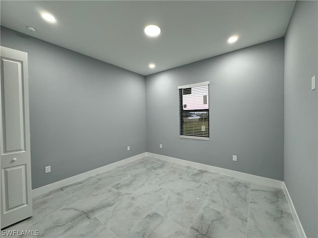 spare room featuring light tile floors