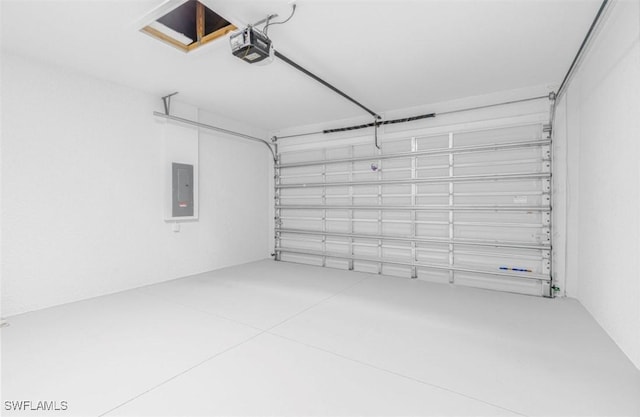 garage with a garage door opener and electric panel