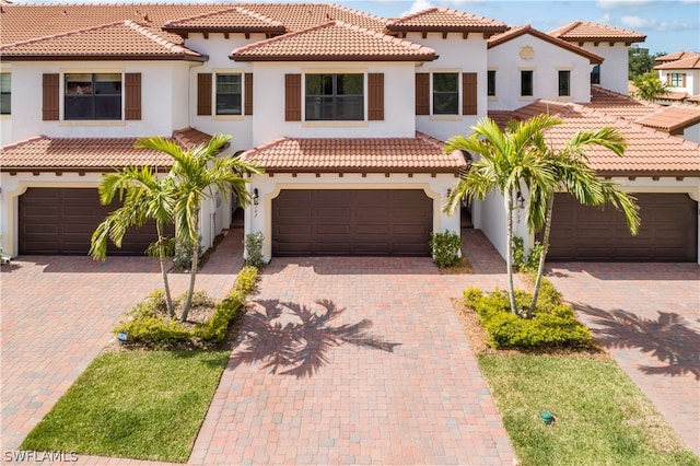 mediterranean / spanish house with a garage