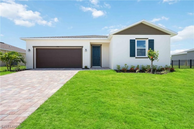 view of front of house featuring a front lawn and a garage