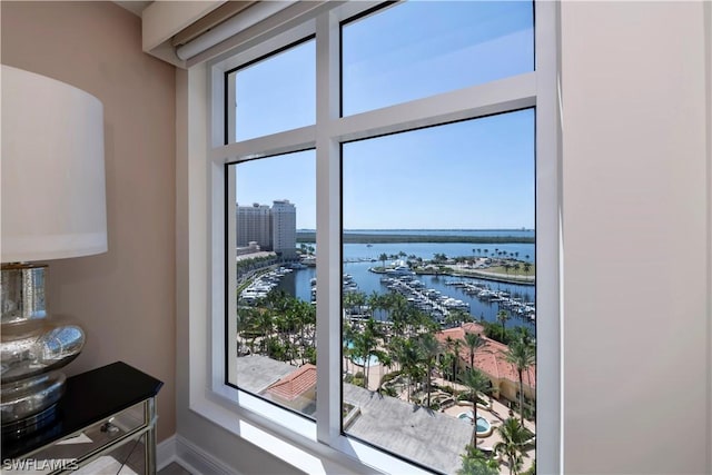 doorway to outside with baseboards and a water view