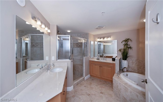 full bathroom featuring two vanities, a stall shower, and a sink