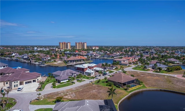 drone / aerial view with a residential view and a water view