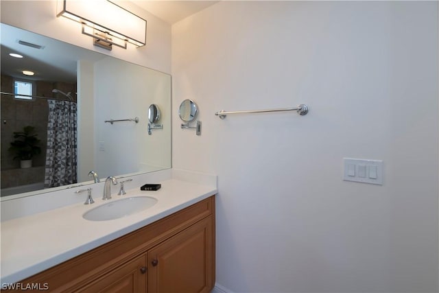 bathroom featuring vanity and curtained shower