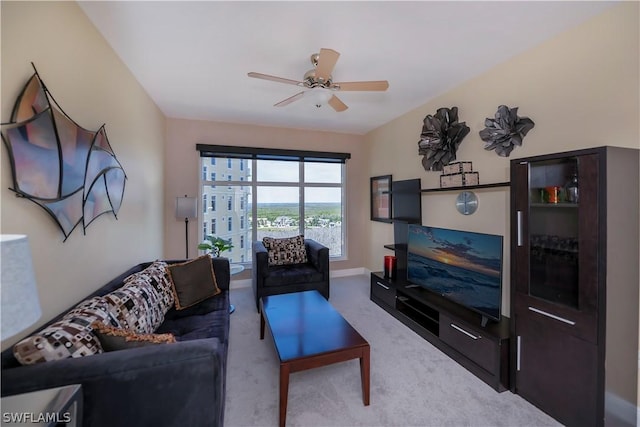 carpeted living room with ceiling fan