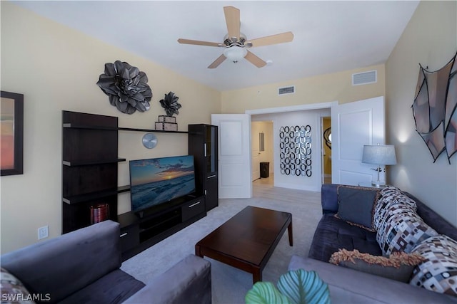 living room with visible vents, carpet, and a ceiling fan