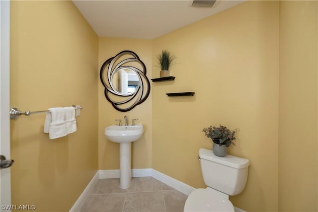 bathroom with tile patterned floors, visible vents, toilet, and baseboards