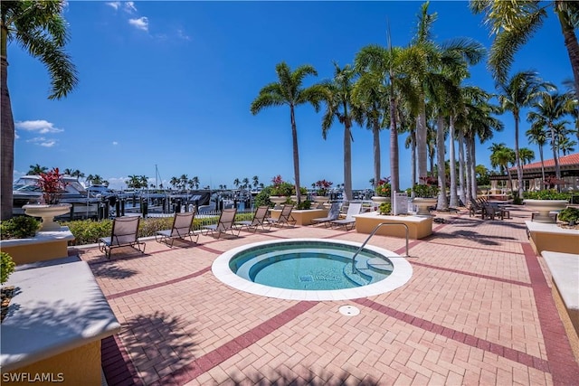 view of swimming pool with a patio area and a hot tub