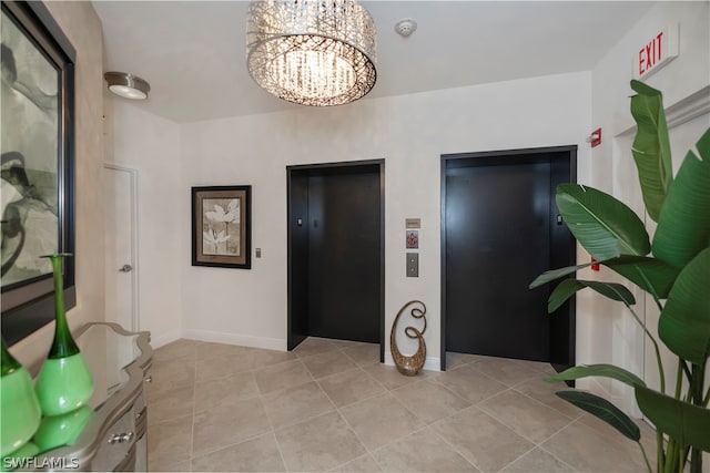 interior space with elevator, light tile patterned floors, baseboards, and an inviting chandelier