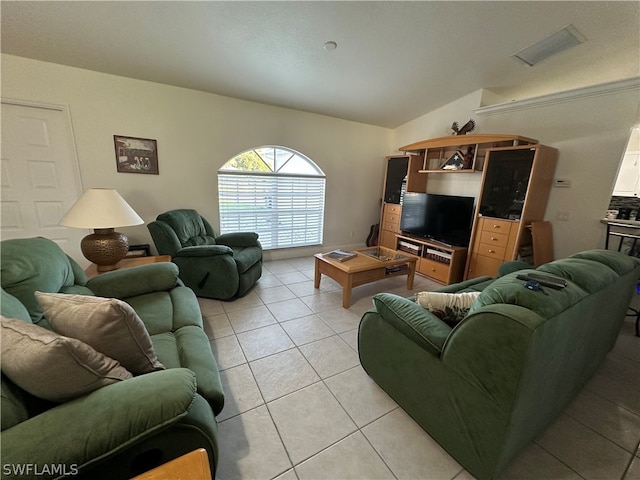 living room featuring vaulted ceiling and light tile floors