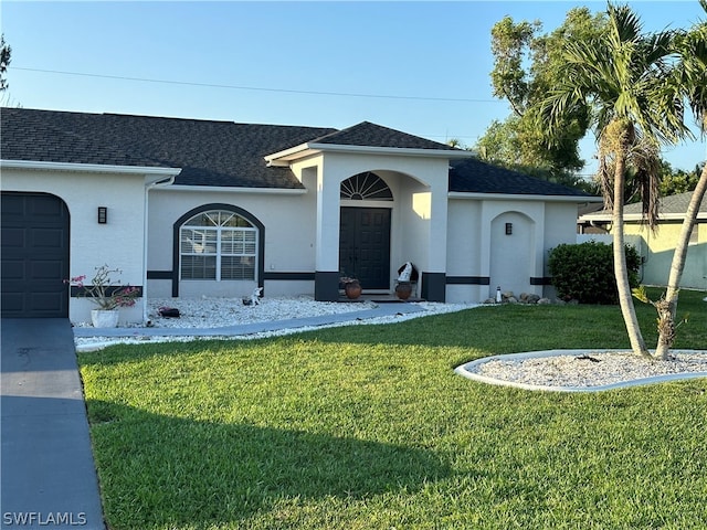 ranch-style house with a front lawn and a garage