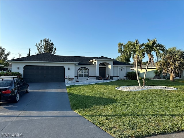 ranch-style home featuring a front lawn and a garage