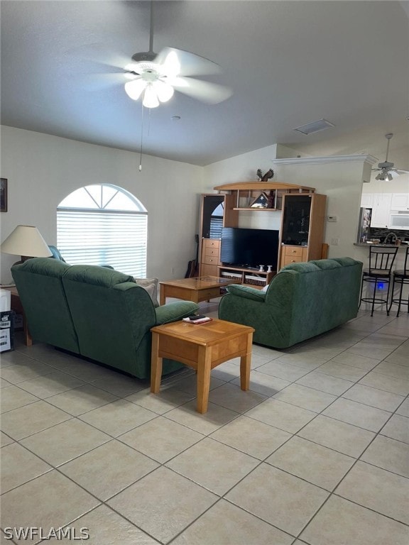 tiled living room featuring ceiling fan