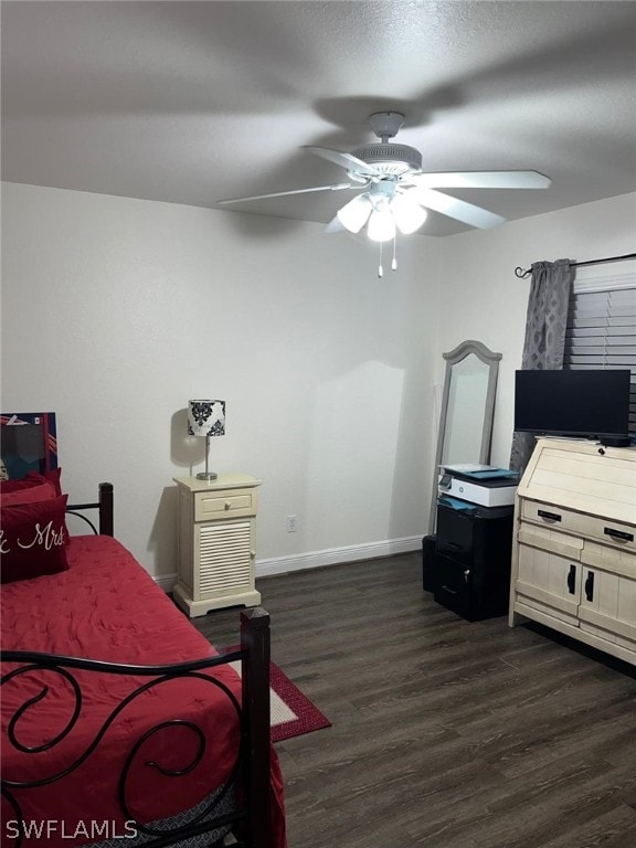 bedroom with dark hardwood / wood-style floors and ceiling fan